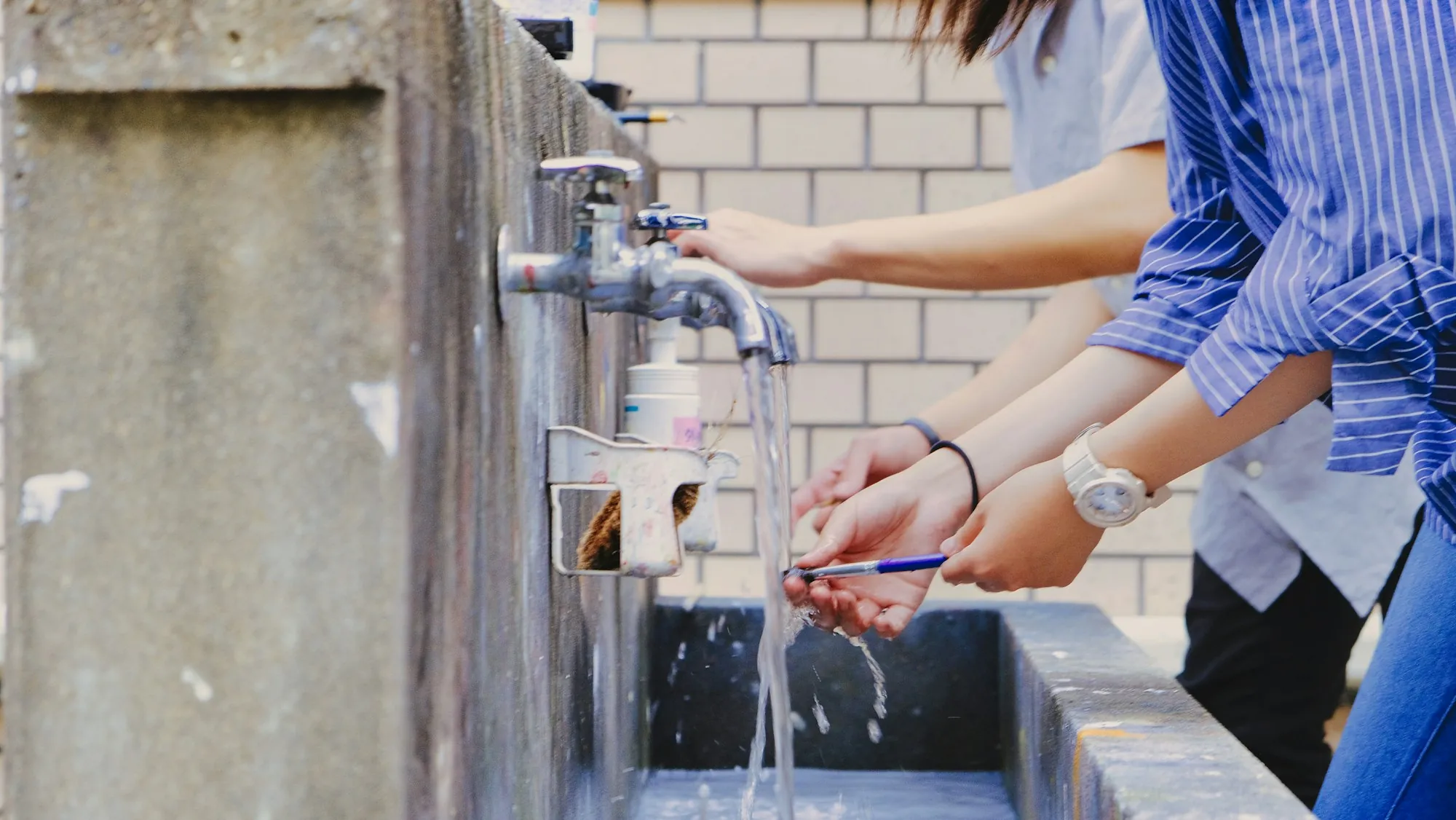 The Santa Ana Water Systems Blog People washing their hands at a row of outdoor faucets