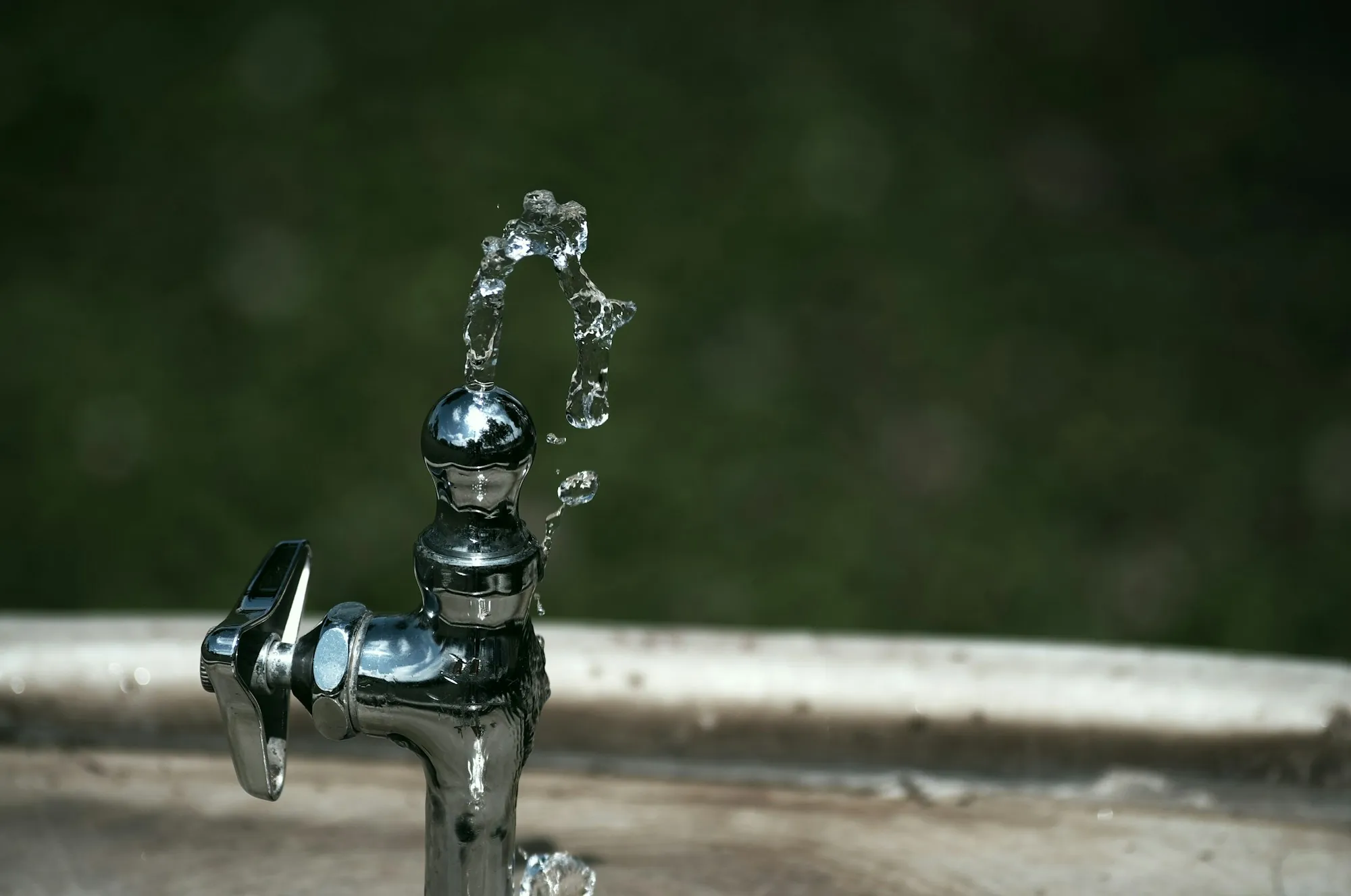 Carbon Filtration Systems in Santa Ana Silver faucet covered in water droplets