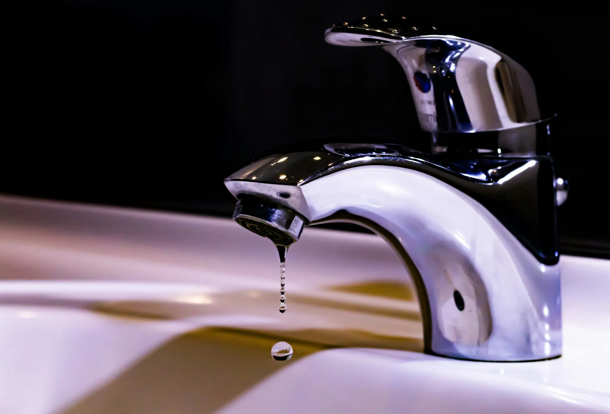 One Local Team, Every System Stainless steel faucet on a white ceramic sink